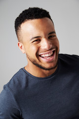 Obraz premium Studio Portrait Of Laughing Man Against Grey Background