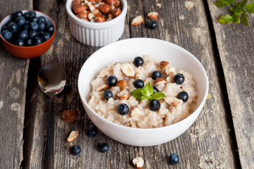 Bowl of oatmeal porridge with blueberry and mint