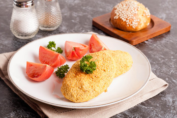 Vegetable cutlets with vegetable and parsley on a white plate