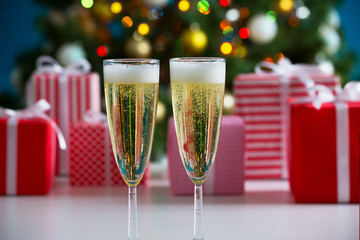 Glasses of champagne and Christmas gifts
