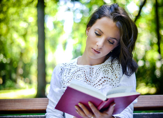 Woman Reading Book Outdoors in Peaceful Forest