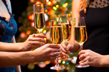 Women's hands with crystal glasses of champagne