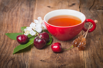 black english tea in red cup with cherry