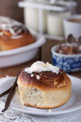 Homemade glazed cinnabons with cinnamon and almonds, american kitchen. Closeup.