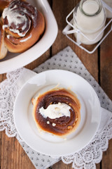 Homemade glazed cinnabons with cinnamon and almonds, american kitchen. Top view.