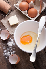 Ingredients and tools ready to make a cake, flour, eggs, butter, cinnamon stick on a wooden table. Selective focus