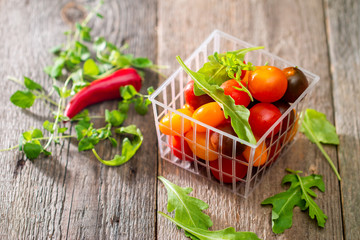 Organic colorful tomatoes in plastic box