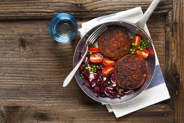 vegetarian burgers lunch with a salad of green peas, tomato and