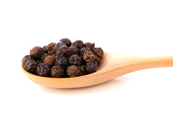 black pepper in wooden spoon solated on white