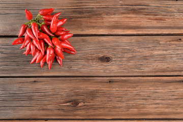 Bunch of chili peppers on old wood