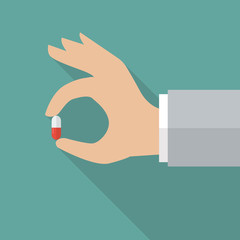 Hand holding medical pill