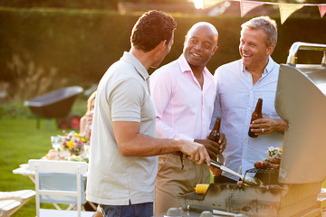 Mature Male Friends Enjoying Outdoor Summer Barbeque