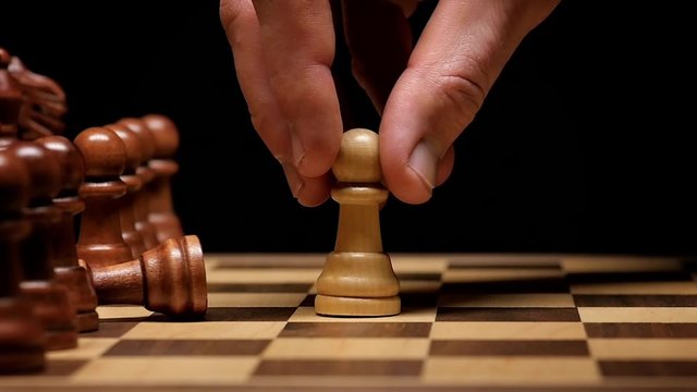 Victorious Pawn Beats Another Pawn, Knocking it over on the chess board