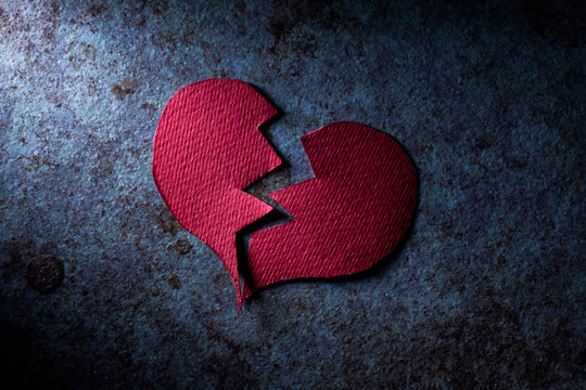 Broken Paper Heart on Blue Grunge Surface