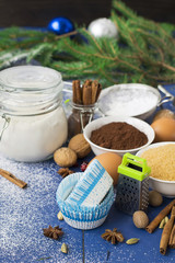 Fototapeta na wymiar Ingredients for baking Christmas muffins on wooden background. s
