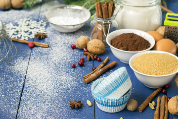Fototapeta na wymiar Ingredients for baking Christmas muffins on wooden background. s