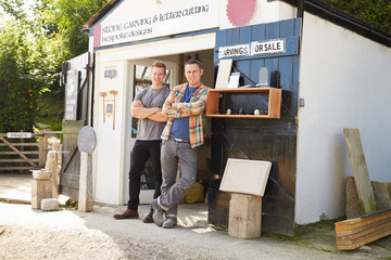 Portrait Of Stone Mason With Apprentice Outside Workshop