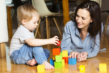 mother play block with his son at home