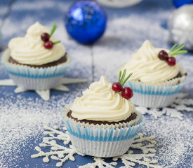 Chocolate cupcake with cream cheese in Christmas decorations