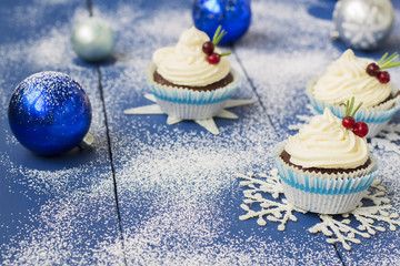 Chocolate cupcake with cream cheese in Christmas decorations
