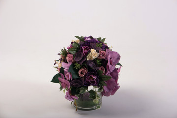 Artificial flowers bouquet in the vase isolated on white