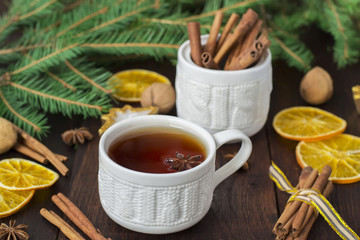 tea with spices in a ceramic cup with Christmas decorations