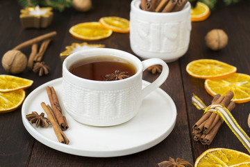 tea with spices in a ceramic cup with Christmas decorations