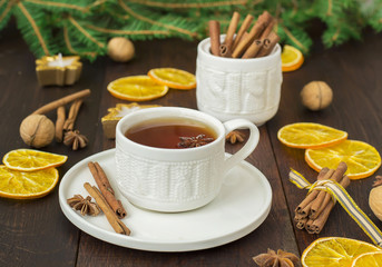 tea with spices in a ceramic cup with Christmas decorations
