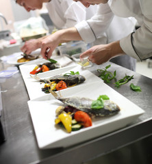 Busy chefs at work in the restaurant kitchen 