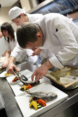 Busy chefs at work in the restaurant kitchen 