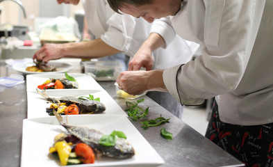 Busy chefs at work in the restaurant kitchen  - 96177574