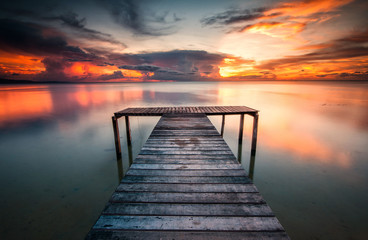 Fototapeta na wymiar jetty and sunset with reflection