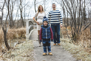 Fototapeta premium Beautiful outdoor pregnant couple portrait in autumn nature