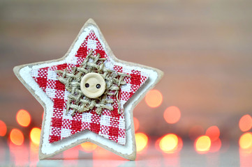 Christmas decoration: Wooden star against Christmas lights
