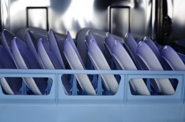glimpse into a dishwasher with freshly washed dishes