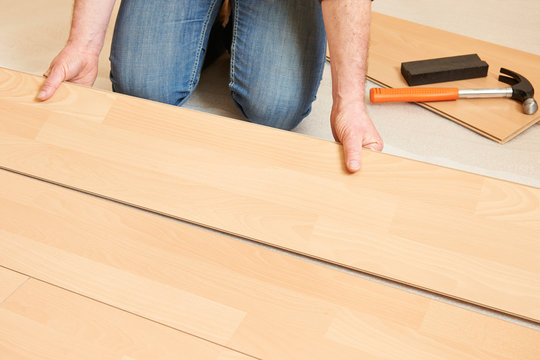 Man Laying Laminate Flooring