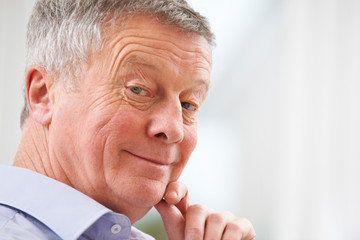 Portrait Of Smiling Senior Man At Home