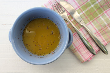 Pumpkin yellow soup in blue dish 
