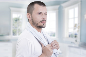 Naklejka premium Man for skin care products in bathroom 