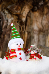 two snowmen from fabric are on the snow