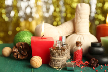 Obraz na płótnie Canvas Beautiful Christmas presents composition on green wooden table against sparkle background, close up