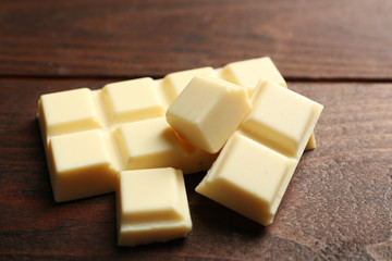 White chocolate pieces on wooden background