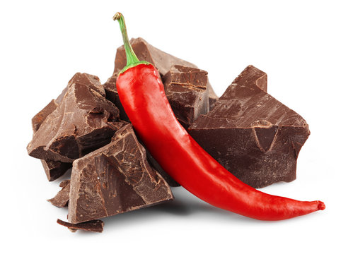 Black chocolate pieces with chili pepper isolated on white