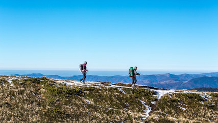 walking couple in carpathian mountains