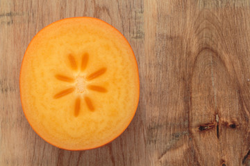 Persimmon, Kaki on rustic wooden table background