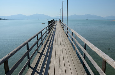 Long wooden pier at Chiemsee lake in Germany