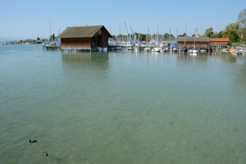 Fototapeta na wymiar Pier, marina and buildings at Chiemsee lake in Germany