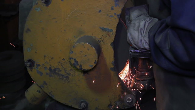 Man grinding blank detail with sparks