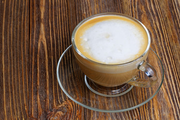 Glass transparent cup with cappuccino