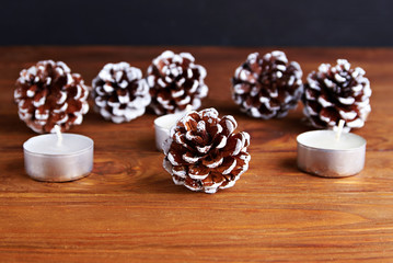 Christmas background with christmas decorations: pine cone and candels